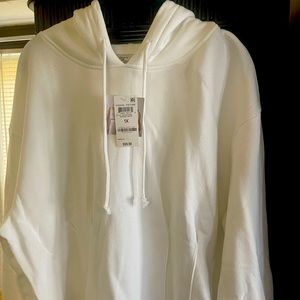 New with tags White sweat shirt, with vertical seams at the bottom. Hip length